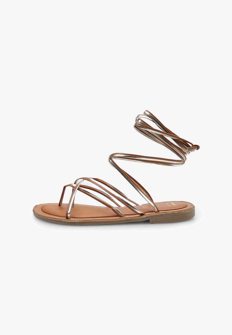 Brown leather sandal with metallic silver straps. Features an open-toe design and a flat sole with a light wood-like finish.