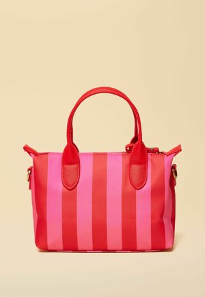 Small handbag with alternating vertical red and pink stripes and red handles on a beige background.