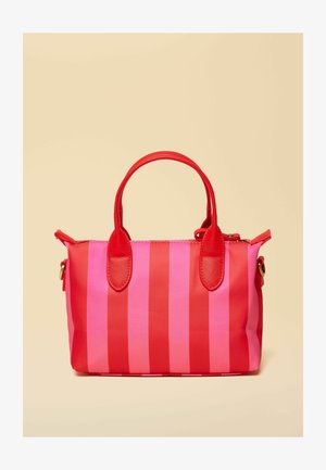 Small handbag with alternating vertical red and pink stripes and red handles on a beige background.