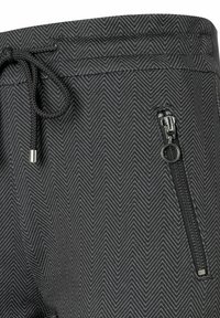 Schwarze Jogginghose mit Fischgrätmuster, ausgestattet mit einem Kordelzugbund und einer seitlichen Reißverschlusstasche mit Metallbeschlägen.