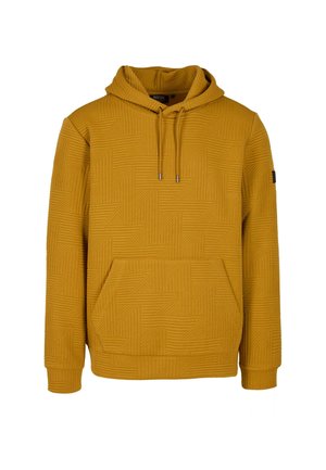 Garstyčių geltonos spalvos pūkinė striukė su tekstūruotu geometrišku raštu. Yra raištelių gobtuvas ir priekinė kišenė. Minkšti, raukiniai rankogaliai ir apykaklė.