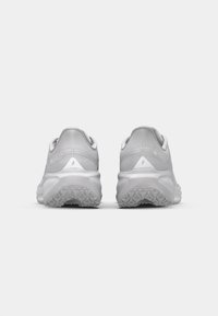 Gray athletic shoes with a textured upper and reinforced heel. Features a rubber sole with a geometric tread pattern for traction.