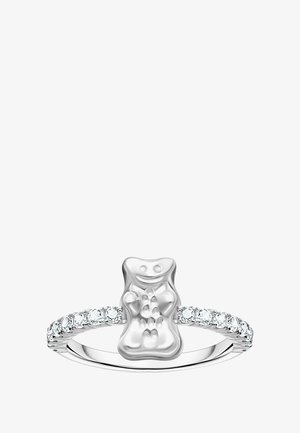 Silberner Ring mit einem Design in Form eines Gummibären und polierter Oberfläche. Das Band ist mit kleinen klaren Edelsteinen verziert.