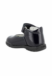 Scarpa Mary Jane nera in pelle verniciata per bambino con cinturino in velcro alla caviglia e robusta suola in gomma nera, vista dal retro.