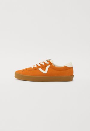 Orange suede sneaker with white accents, round toe, and beige laces. Features a textured rubber sole and smooth inner lining.