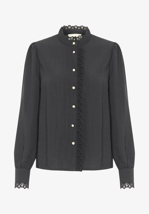 Mustmust kuub s tume pitsist kraega, ees klappnupud pärlidega, pikad puhvunud varrukad, pitsäärised mansettidel ja sile tekstuur.