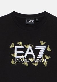 Čierne bavlnené tričko s centrálnym bielym a žltým grafickým dizajnom s logom "EA7" a značkou "Emporio Armani", s okrúhlym výstrihom.