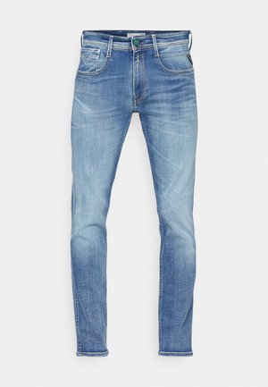 Light blue denim jeans with a slim fit, featuring five pockets, a button closure, and subtle fading throughout the fabric.