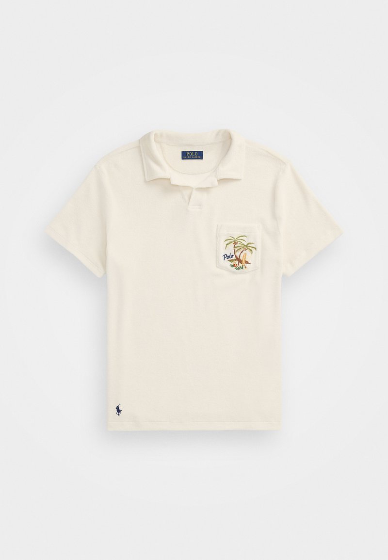 Kremo spalvos polo marškiniai su trumpomis rankovėmis, apykakle ir krūtinės kišene, dekoruota palmių medžio siuvinėjimu. Tamsiai mėlynas logotipas apatiniame krašte ir etiketėje. Pagaminta iš medvilnės.