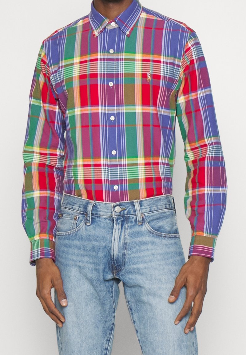 Camicia abbottonata con un vivace motivo a quadri nei colori rosso, verde, blu e giallo. Realizzata in misto cotone, con maniche lunghe.