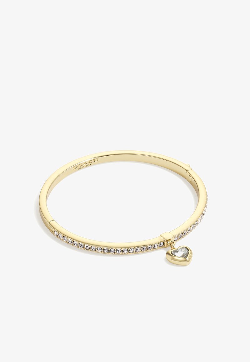 Gold bangle bracelet featuring a row of small crystals and a dangling heart charm with a clear stone. Smooth metal surface and clasp closure.