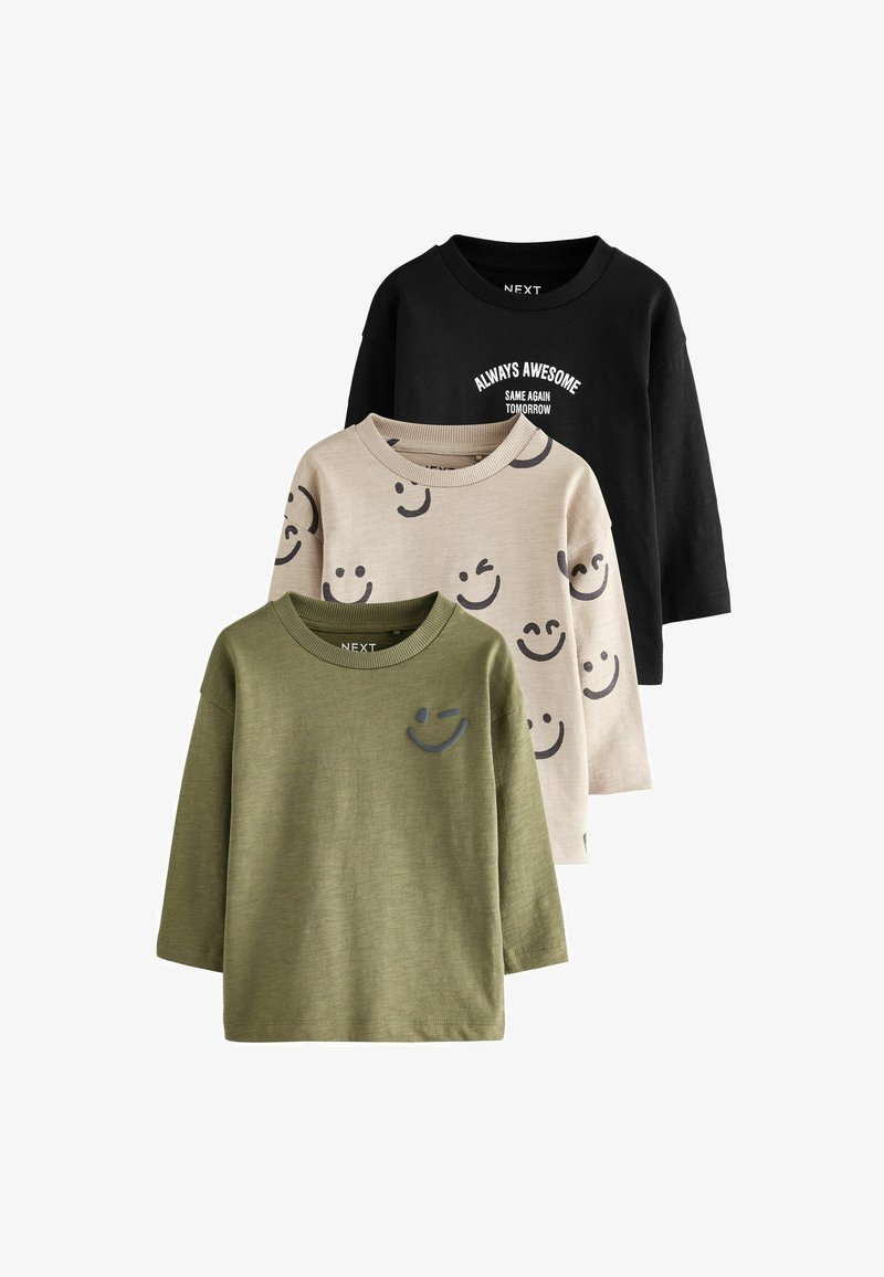 Three long-sleeve children's shirts in black with text, beige with smiley faces, and olive green with a small smiley face on the chest.