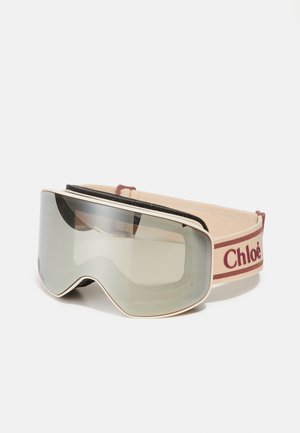 Chloé slēpošanas brilles ar noapaļotu rāmi, gaišu zelta detalizāciju, spoguļa lēcām un mīkstu bēškrāsas elastīgu siksnu ar bordo logotipu.