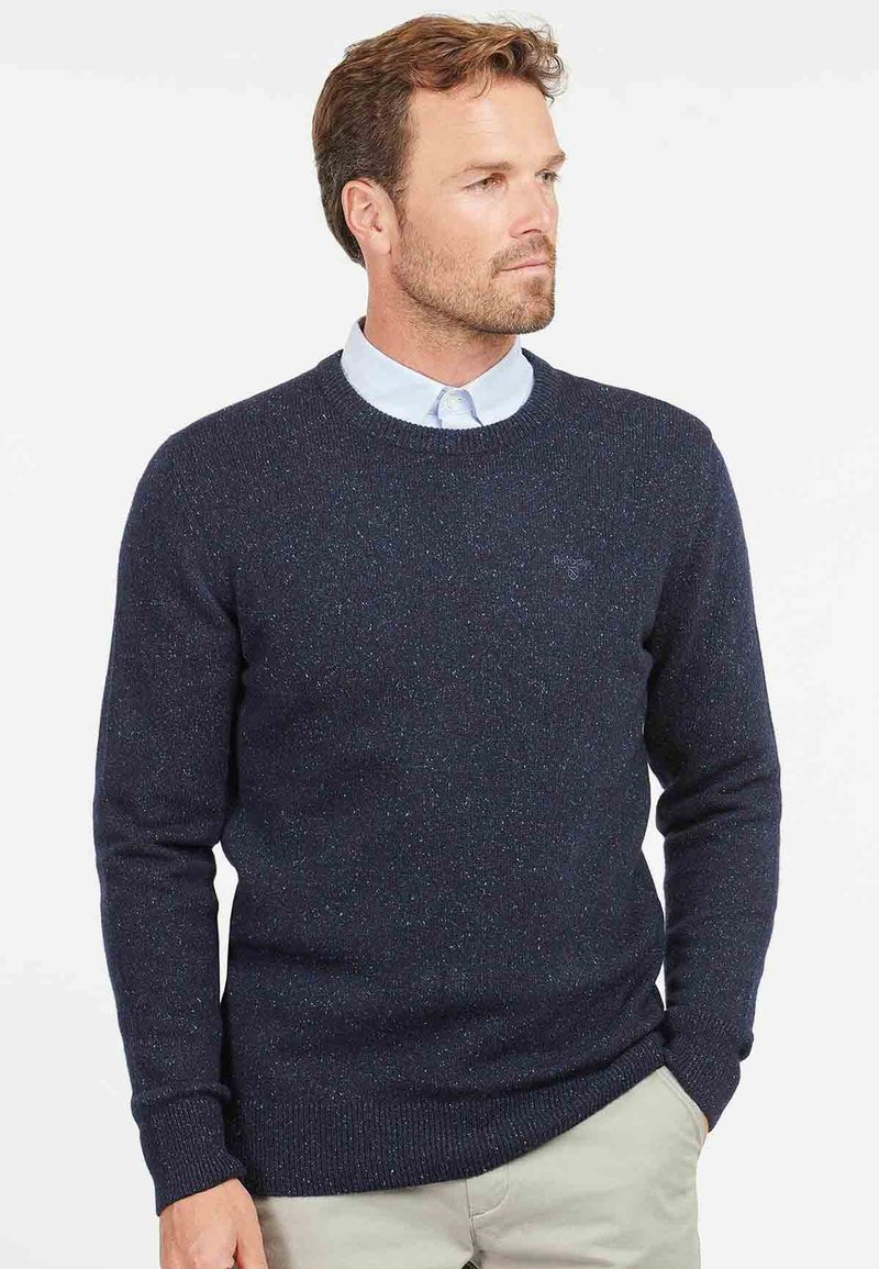 Dark blue knitted crew-neck sweater with textured fabric. Features ribbed cuffs and hem, showcasing subtle specks of color throughout.