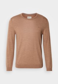 Brown long-sleeve sweater made of lightweight material, featuring a round neckline and subtle logo detailing on the chest. Smooth texture.