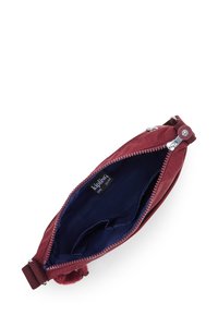 Burgundy fabric bag with zip closure, featuring a smooth exterior, a dark blue interior lining, and a small branding tag inside.
