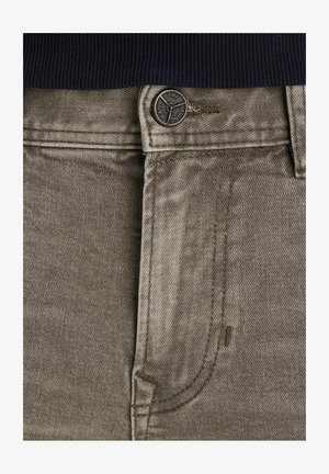 Jeans in denim beige con una superficie liscia, dotati di un bottone con logo del marchio e dettagli della tasca frontale.
