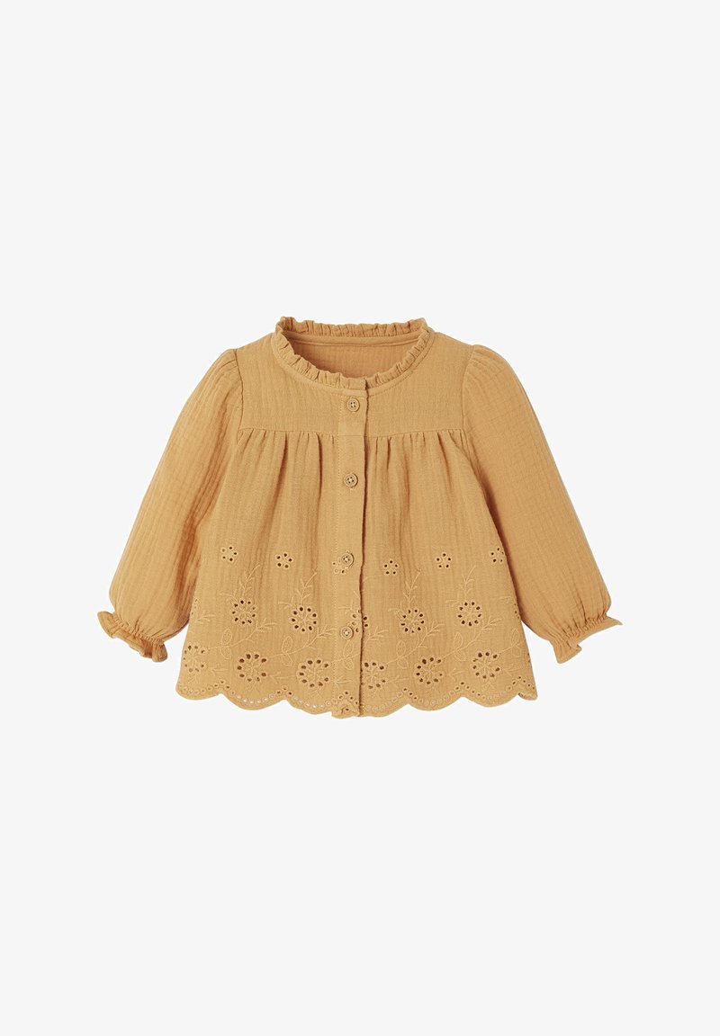 Long-sleeve, mustard yellow blouse with ruffled collar, button front, and embroidered floral pattern along the hem. Textured fabric.