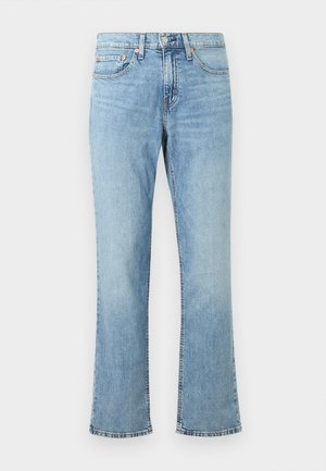 Jeans svasati azzurri chiari in denim. Caratterizzati da una chiusura con bottone e cerniera, cinque tasche e dettagli di cucitura arancione lungo le cuciture.