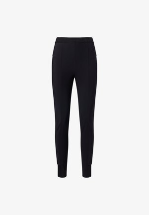 Zwarte stretchbroek met een brede elastische tailleband, voorzien van twee voorzakken en taps toelopende benen, vervaardigd uit een gladde stof.
