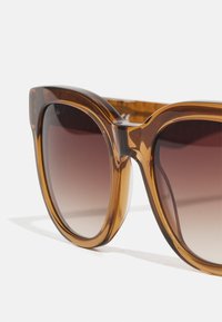 Lacoste Óculos de sol - transparent caramel