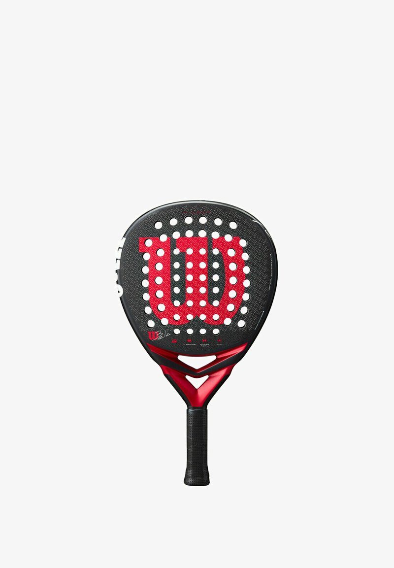 Wilson padel racket featuring a black surface with red accents, circular perforations, and textured grip handle. Designed for durability and performance.