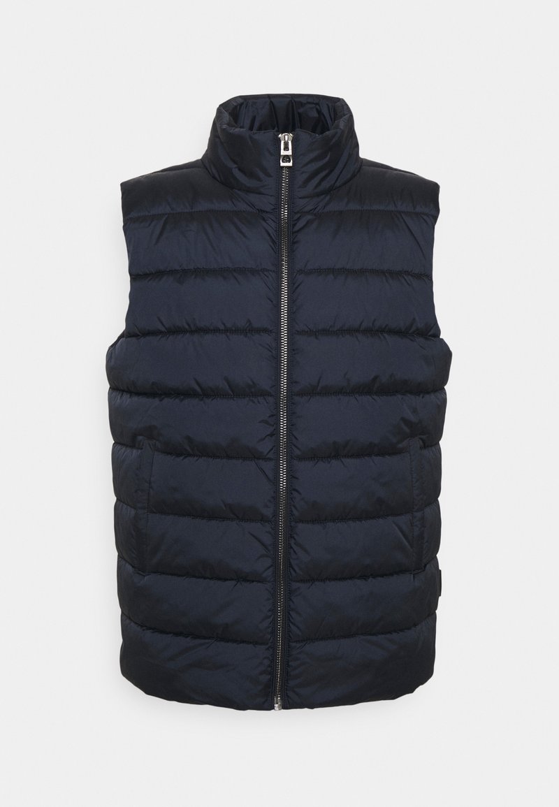 Gilet matelassé navy avec un col haut, motif matelassé horizontal, fermeture éclair à l'avant et poches latérales. Fabriqué en tissu léger et lisse.