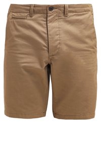 Pantalones cortos de algodón marrón con un frente plano, un bolsillo lateral, y un ajuste regular con pasadores para cinturón y cierre de botón.