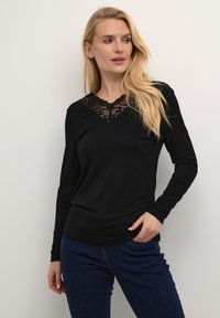 Top nero a maniche lunghe con scollatura a V, pannello in pizzo testurizzato sul collo, tessuto morbido e silhouette aderente.
