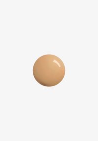Beige cream product in a glossy finish, round shape, smooth texture, with a soft and uniform color.