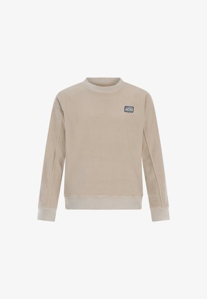 Sweatshirt en polaire beige à manches longues, avec un col et des poignets côtelés. Présente un petit patch logo bleu sur la poitrine. Texture douce.