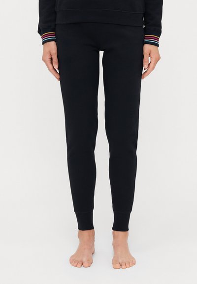 Crne trenirke od mekanog materijala, sa slim fit krojem i rebrastim manžetama. Elastični pojas osigurava udobnost.