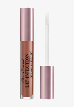 Lippenbalsam in einem klaren, zylindrischen Behälter mit einer metallischen roségoldenen Kappe. Enthält einen Applikator mit Schaumstoffspitze in Weiß.