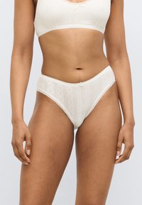 Εσώρουχα τύπου briefs σε κρεμ χρώμα με κάθετες ρίγες και μικρά διαμαντένια σχέδια, με φιόγκο στο μπροστινό μέρος και λεπτή δαντέλα στη διακόσμηση.