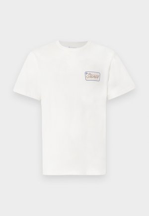 White cotton t-shirt with short sleeves, featuring a small rectangular logo patch on the left chest with colorful text and border.