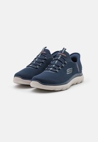Navy sneakers with a textured mesh upper, elastic laces, and a cushioned white sole. Features a logo and subtle gray accents.
