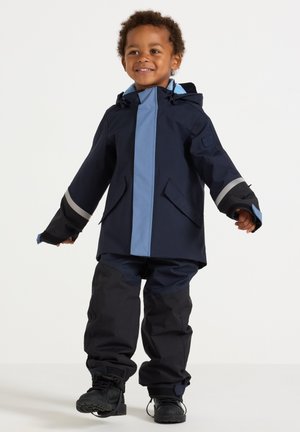 Navy waterproof jacket with light blue accents and reflective stripes, paired with matching pants and black boots, designed for children.