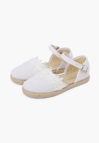 Baskets espadrilles blanches avec des accents de dentelle florale, texture tressée et bride de cheville. Elles présentent une semelle plate en corde de jute et un bout arrondi.