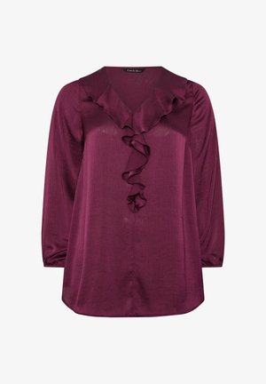 Burgunderfarbene Bluse mit langen Ärmeln, ausgestattet mit einem V-Ausschnitt und einem zentralen Rüschendetail. Hergestellt aus weichem, glänzendem Stoff mit einer subtilen Textur.