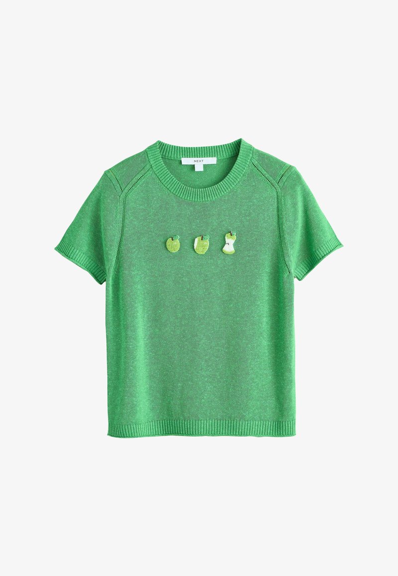Pull en tricot à manches courtes vert avec bords côtelés et trois petits motifs de pommes illustrant les stades entier, coupé en deux et croqué, centrés sur la poitrine.