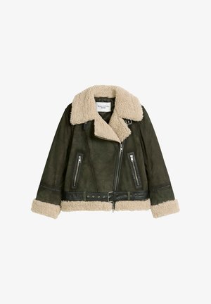 Short shearling jacket in dark green leather, featuring a beige shearling collar, zippered pockets, and a belted waist with hardware accents.