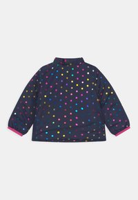 Water-resistant, navy jacket featuring colorful, reflective polka dots, long sleeves, and a high collar with pink trim at the cuffs.