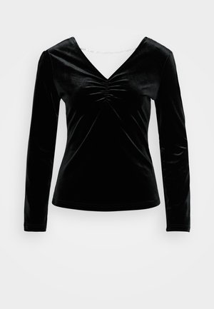Black velvet long-sleeve top with a V-neck and gathered detail at the bust. Soft texture, fitted design, and a smooth finish.