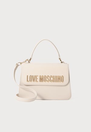 White faux leather handbag with a gold logo accent. Features a top handle and adjustable shoulder strap. Smooth texture, rectangular shape.
