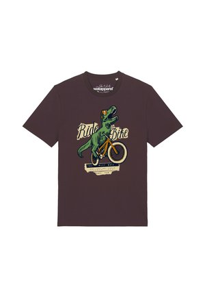 T-shirt marron foncé avec un graphisme d'un T-Rex vert chevauchant un vélo orange et le texte "Ride a Bike" au-dessus.
