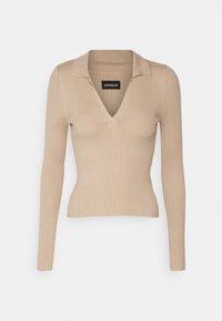 Beige gerippter Langarmoberteil mit V-Ausschnitt und Kragen, figurbetontes Design, aus weichem Material, mit einem Etikett mit dem Markennamen innen.