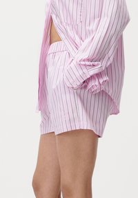 Rosa stripete kort pysjamassett med knapp-up skjorte og elastisk midje shorts, laget av glatt stoff med en subtil glans.