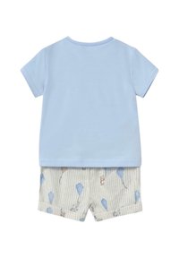 Camiseta de algodón azul claro de manga corta combinada con pantalones cortos beige que presentan patrones de osos grises y kites en finas rayas.