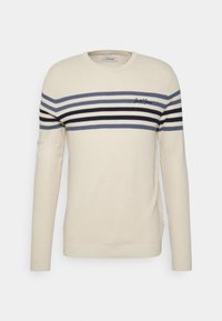 Maglione beige chiaro con strisce orizzontali blu navy, grigie e nere. Tessuto a maglia testurizzato con collo a giro e polsini a coste. Dettaglio del logo.