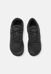 Black athletic shoes with a breathable mesh upper, textured detailing, and rugged rubber outsole. Features traditional lacing system.
